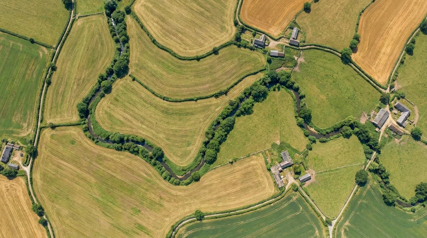 Four satellite image layers in an exploded stack, from a grey panchromatic band at the top to a colour-balanced scene at the bottom